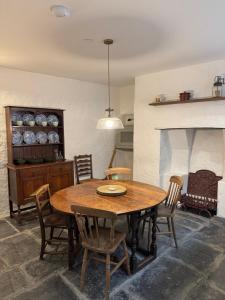 a dining room with a wooden table and chairs at Fishermans Cottage at The Old Library in Aberystwyth