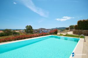 a large swimming pool in a yard with a view at Villa con piscina by budoniaffiti in Budoni