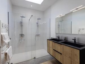 a bathroom with a glass shower and a sink at Le Gwern by Madame est Servie in Pleumeur-Bodou +12 photos