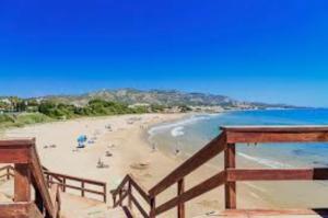 a view of a beach with people on the sand at Marcotin Piscina playa y montaña in Alcossebre