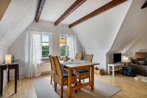 a dining room with a table and chairs at Fewo Silbermöwe in Pellworm