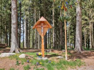 a wooden bird house in the middle of a forest at Ferienwohnungen Schönwald in Schonwald im Schwarzwald +46 photos