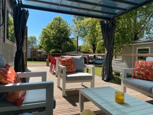 a patio with chairs and a table on a deck at Les bord du Lac Leman in Sciez