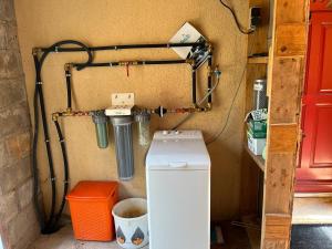 a garage with a washer and a refrigerator in it at Montagnac in Gignac +26 photos