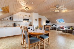 a kitchen and living room with a table and chairs at Ferienwohnung Schillinger in Sasbach am Kaiserstuhl