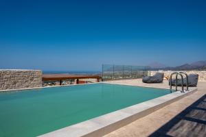 a swimming pool with a view of the mountains at Infinity View Luxury Villas in Galiá