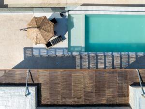 an umbrella on the side of a swimming pool at Infinity View Luxury Villas in Galiá