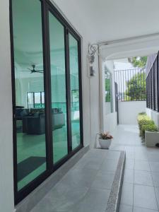a hallway of a house with sliding glass doors at 8ight Guesthouse 8号民宿 in Kluang