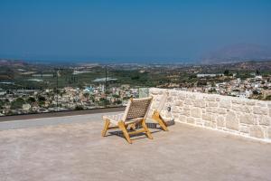two chairs sitting on top of a wall with a view at Infinity View Luxury Villas in Galiá +30 photos