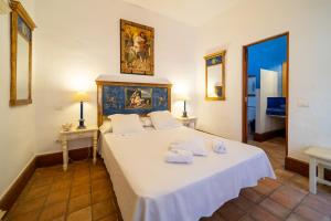 a bedroom with a large bed with two towels on it at La Casona de Yaiza I Hotel Emblematico in Yaiza +107 photos