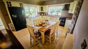 a kitchen with a wooden table with chairs and a kitchen sidx sidx sidx at Devlin's cottage near Slane in Slane