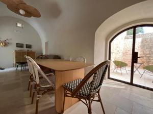 a dining room with a wooden table and chairs at Cascina Filomena in Polignano a Mare