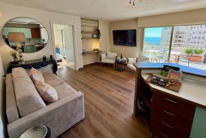 a living room with a couch and a large mirror at French Riviera - Monaco in Beausoleil