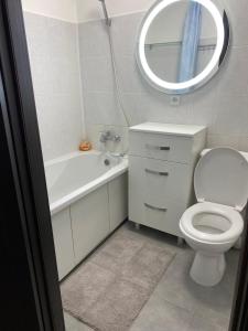 a bathroom with a toilet and a sink and a mirror at Апарт Безручка in Rivne +1 photo