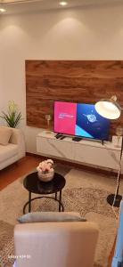 un soggiorno con tv e tavolo di Irina Blessed Homes Bonanjo 1 a Douala