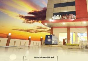 a view of a building with a rainbow in the sky at Hotel Alfatih Banda Aceh in Banda Aceh