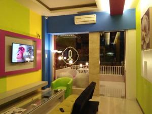 a room with a room with a tv and a room with at Hotel Alfatih Banda Aceh in Banda Aceh