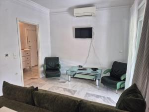 a living room with a couch and two chairs and a table at Lovely place in Perea in Perea