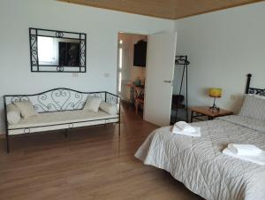 a living room with two beds and a couch at Casa Esmeralda in Borbén +49 photos