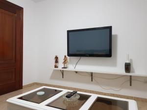a living room with a flat screen tv on a wall at Casa Esmeralda in Borbén