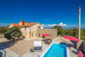 a villa with a swimming pool and a house at Villa Mediteran with private pool in Vrh