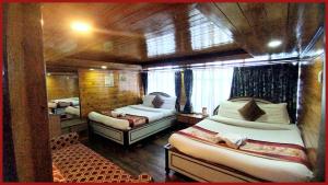 a small room with two beds and a couch at A Top Rated Hotel B-R-O-A-D-A-Y - Mall Road - Luxury & Spacious Room - Book Now in Darjeeling