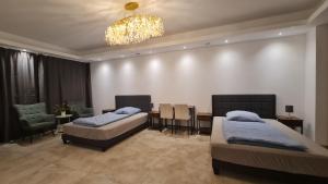 a bedroom with two beds and a chandelier at Gästehaus Ferienwohnung Wohnung #1 Jülich in Jülich