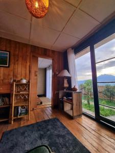 a living room with a large window and a table at Khaya Nzuri Musanze in Gasanze +12 photos