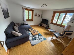 a living room with a couch and a table at Chasa Janett in Martinsbruck