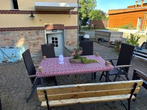 a table and chairs with a tablecloth on a patio at Ferienwohnung "Luther" in Blankenburg