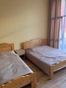 a bedroom with two twin beds and a window at glory hotel kobuleti in Kobuleti