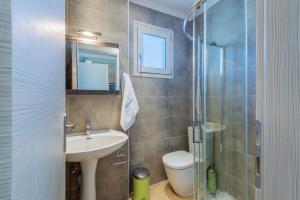 a bathroom with a sink and a toilet and a shower at Pansion Ermioni in Skala
