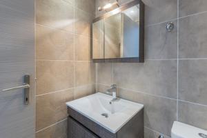 a bathroom with a sink and a mirror at Pansion Ermioni in Skala