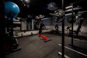 a room with a gym with weights and equipment at Nomio in Tivat