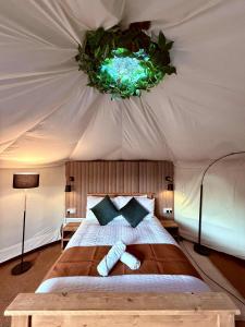 a bedroom with a bed in a tent at Between Rivers Camping @ The Old George Inn in Sykehouse