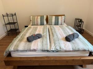 a bed with two pairs of hats on it at Dom przy lesie in Koniecwałd