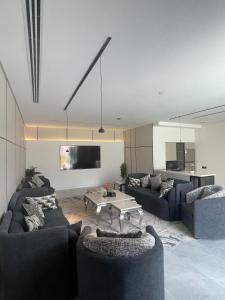a living room with two couches and a table at Luxury Escape W DAMMS chalet Private Pool in Riyadh