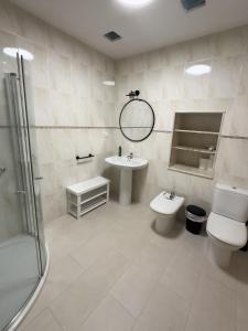 a bathroom with a sink and a toilet and a shower at Go Compostela Apartamento 4 pax in Sarria +20 photos