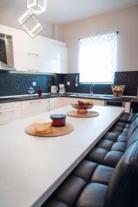 a kitchen with two bowls of fruit on a counter at Luxury Suite Prada in Paleokastritsa
