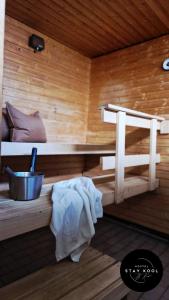 a sauna with a bench and a sink in it at Stay Kool in Kiuruvesi