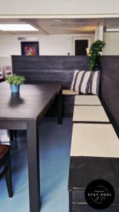 two benches in a room with a table and plants at Stay Kool in Kiuruvesi +25 photos