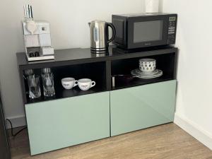 a microwave oven sitting on top of a counter at Delightful Self Contained Garden View Retreat in Wincobank