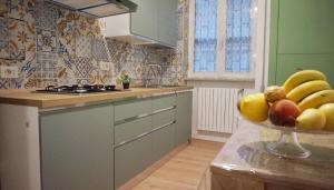 a kitchen with a bowl of fruit on a counter at Casa Mamy Pompei 2 in Pompei