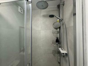 a shower with a glass door in a bathroom at Delightful Self Contained Garden View Retreat in Wincobank