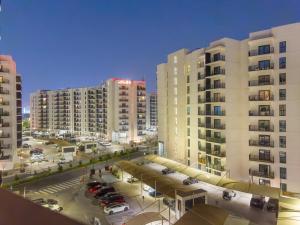 a view of a parking lot with tall buildings at FIRST CLASS 1BR Tranquility in Style in Abu Dhabi
