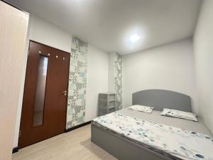 a bedroom with a bed and a brown door at Villa in the center of Yerevan in Yerevan +22 photos