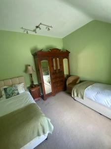 a bedroom with two beds and a mirror at 2 Bed Courtyard Apartment at Rockfield House Kells in Meath - Short Term Let in Kells