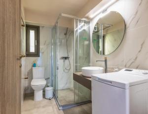 a bathroom with a toilet and a sink and a mirror at Azure Sofia - Grounded in Kos +5 photos