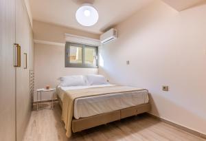 a bedroom with a bed in a room with a window at Azure Sofia - Grounded in Kos
