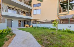 a building with a walkway in front of a yard at Azure Sofia - Grounded in Kos